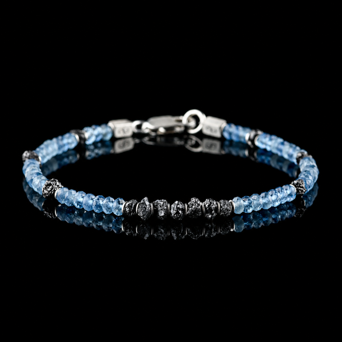 Front view of Raw Black Diamond - Aquamarine Bracelet I (4mm), showing the complete bracelet on a black reflective surface.