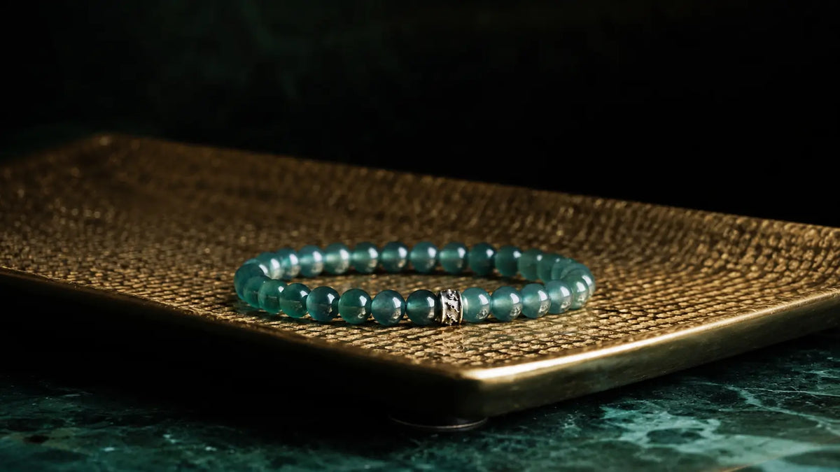 Close view of a jade bracelet with richly colored green stones