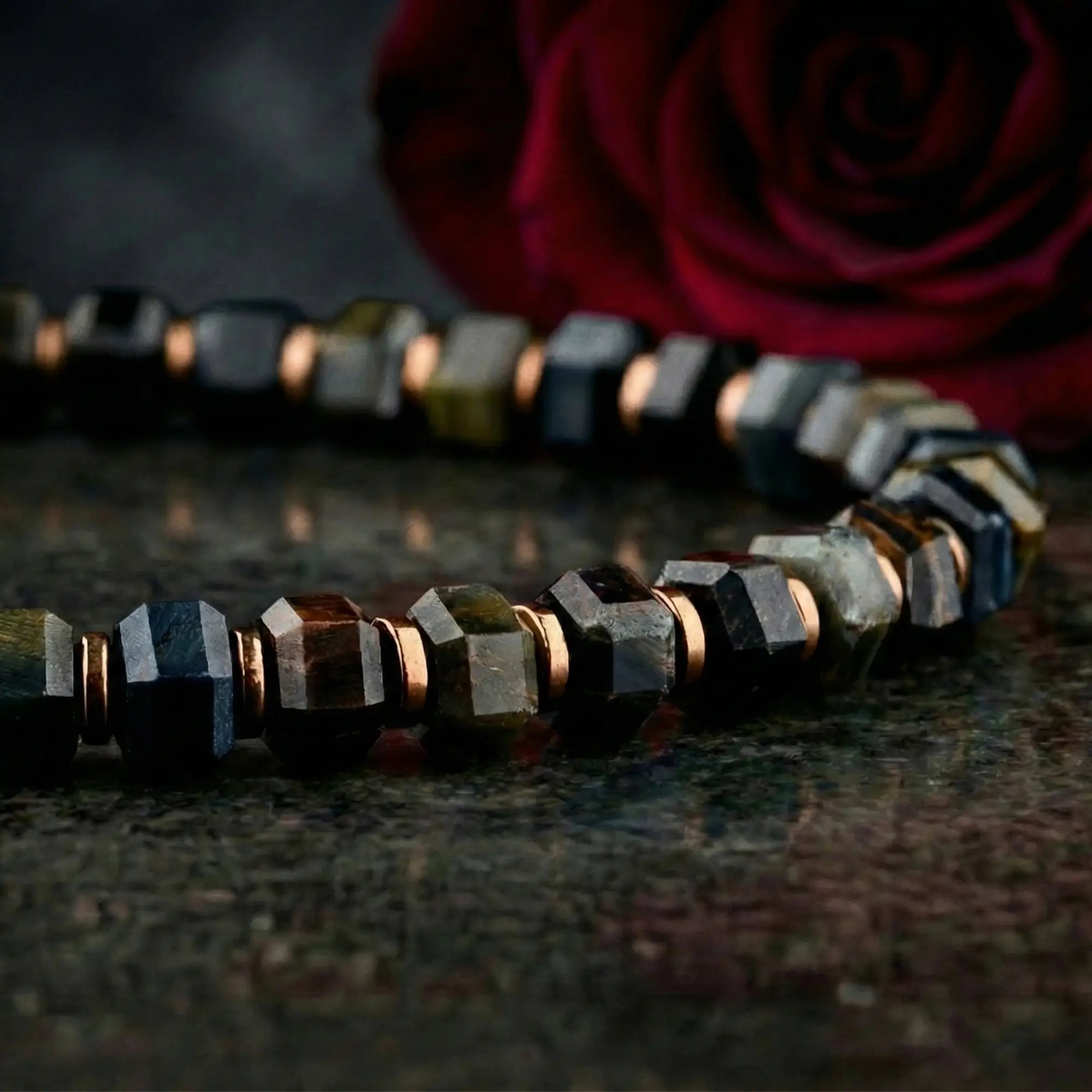 Blue tiger eye bracelet for men with red rose, lifestyle view. 6mm Hawk's Eye design. Aurum Brothers.